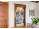 Custom built-in bar with glass shelves, stylish tile backsplash, and elegant lighting at 4818 Bryant St, Denver, CO 80221