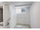 A compact bathroom with a toilet, window and direct access to the shower room at 4818 Bryant St, Denver, CO 80221
