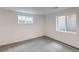 A minimalist bedroom with two windows allowing ample light at 4818 Bryant St, Denver, CO 80221