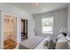 Bright bedroom featuring a closet, large windows, and comfortable furnishings at 4818 Bryant St, Denver, CO 80221