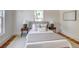 Serene bedroom with hardwood floors, neutral tones, and stylish side tables at 4818 Bryant St, Denver, CO 80221