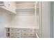 Bright walk-in closet featuring white shelving, drawers, and ample storage space for an organized wardrobe at 4818 Bryant St, Denver, CO 80221