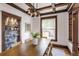 Dining room with decorative lighting, dining table and chairs, and glass cabinet at 4818 Bryant St, Denver, CO 80221