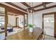 Dining room featuring wood trim, a dining table with seating, and modern light fixture at 4818 Bryant St, Denver, CO 80221