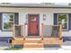 Welcoming front porch with wooden railing, new boards and a bright red front door at 4818 Bryant St, Denver, CO 80221