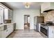 Well-lit kitchen with stainless steel appliances, ample counter space, and stylish fixtures at 4818 Bryant St, Denver, CO 80221