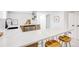 Bright kitchenette featuring a long quartz countertop with wooden cabinets and modern black fixtures at 4818 Bryant St, Denver, CO 80221