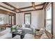 Cozy living room with a comfortable gray sofa, hardwood floors, wood trim, and two windows at 4818 Bryant St, Denver, CO 80221