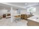 Open-concept living room with a kitchenette and a cozy seating area with neutral colors and decor at 4818 Bryant St, Denver, CO 80221