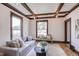 Cozy living room with a comfortable gray sofa, hardwood floors, wood trim, and natural light at 4818 Bryant St, Denver, CO 80221