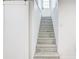 Modern staircase with gray patterned wood steps leading to the upper level of the home at 4818 Bryant St, Denver, CO 80221