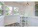 Bright sunroom features a wall of windows, wood floors, and decorative built-in shelving at 4818 Bryant St, Denver, CO 80221