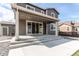 Exterior of house featuring a large patio with steps leading to the backyard at 27615 E Archer Ave, Aurora, CO 80018