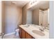 Bathroom featuring double sinks, a large mirror, and a shower and toilet at 27615 E Archer Ave, Aurora, CO 80018