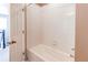 Bright bathroom showcases a white tiled shower-tub combination, with a clear glass shower door at 27615 E Archer Ave, Aurora, CO 80018