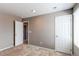 Neutral bedroom featuring carpet, tan walls, and white trim on doors and baseboards at 27615 E Archer Ave, Aurora, CO 80018
