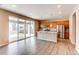 Spacious kitchen flowing into living area, featuring stainless steel appliances, granite island, and access to backyard at 27615 E Archer Ave, Aurora, CO 80018
