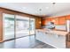 Beautiful kitchen with stainless steel appliances, a granite island, wooden cabinetry, and sliding door to backyard at 27615 E Archer Ave, Aurora, CO 80018