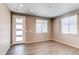 A bright living room featuring light-colored walls, wood floors, and windows that let in plenty of natural light at 27615 E Archer Ave, Aurora, CO 80018