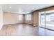 Bright living room featuring hardwood floors, recessed lighting, and sliding glass doors leading to a patio at 27615 E Archer Ave, Aurora, CO 80018
