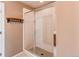Glass enclosed walk-in shower with neutral tile surround and modern fixtures at 27615 E Archer Ave, Aurora, CO 80018