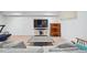 Bright finished basement including a lounge area with a large television and a unique display cabinet at 3035 S Indiana St, Lakewood, CO 80228