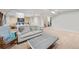 Finished basement featuring a lounge area with plush seating and an adjacent bedroom at 3035 S Indiana St, Lakewood, CO 80228