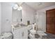 Practical bathroom featuring a modern sink and a glass-enclosed shower, complemented by sleek cabinetry at 3035 S Indiana St, Lakewood, CO 80228