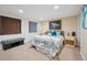 Cozy bedroom featuring carpeted floors, a comfortable bed, and stylish decor at 3035 S Indiana St, Lakewood, CO 80228
