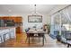 Open dining area with hardwood floors, modern lighting, and sliding glass door to backyard patio at 3035 S Indiana St, Lakewood, CO 80228
