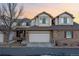 Charming townhouse features a two-car garage and a mix of brick and neutral siding at 3035 S Indiana St, Lakewood, CO 80228