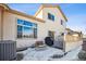 Rear exterior view showcases the patio, large windows, and well-maintained siding at 3035 S Indiana St, Lakewood, CO 80228