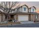 Charming townhouse features a two-car garage and a mix of brick and neutral siding at 3035 S Indiana St, Lakewood, CO 80228