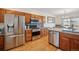 Bright kitchen featuring stainless steel appliances, granite countertops, and wood cabinets at 3035 S Indiana St, Lakewood, CO 80228