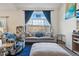 Bright living room with a large window, couch, and sitting chairs at 3035 S Indiana St, Lakewood, CO 80228