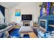 Cozy living room with a fireplace, television, and comfortable seating at 3035 S Indiana St, Lakewood, CO 80228