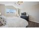 Spacious main bedroom with a large window offering mountain views and a ceiling fan for added comfort at 3035 S Indiana St, Lakewood, CO 80228