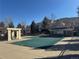 Community pool covered for the off-season with clubhouse and fence line behind it at 3035 S Indiana St, Lakewood, CO 80228