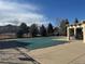Community pool covered for the off-season with clubhouse and trees in the background at 3035 S Indiana St, Lakewood, CO 80228