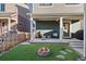 Covered back porch with outdoor seating and a fire pit, great for entertaining at 1143 Hummingbird Cir, Longmont, CO 80501