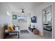 Bright bedroom with a comfortable sofa, ceiling fan, and convenient access to the adjacent bedroom at 1143 Hummingbird Cir, Longmont, CO 80501