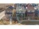 Charming two-story home with a green and beige exterior, complemented by a neatly landscaped front yard at 1143 Hummingbird Cir, Longmont, CO 80501