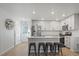 Modern kitchen boasts white cabinets, stainless steel appliances, island with seating, and bright lighting at 1143 Hummingbird Cir, Longmont, CO 80501