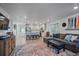 Open-concept living space boasts a colorful rug, comfortable seating, and seamless flow to the kitchen at 1143 Hummingbird Cir, Longmont, CO 80501