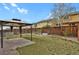 Fenced backyard featuring a patio and gazebo, surrounded by green grass and landscaping at 12685 E 104Th Pl, Commerce City, CO 80022