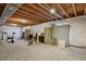 Unfinished basement with exposed ceiling and carpeted floor, offering potential for customization at 12685 E 104Th Pl, Commerce City, CO 80022