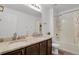 Bathroom featuring a double sink vanity with granite countertops, a shower, and a tub at 12685 E 104Th Pl, Commerce City, CO 80022