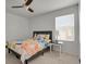 Cozy bedroom with large window for natural light and ceiling fan at 12685 E 104Th Pl, Commerce City, CO 80022