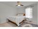 Bright bedroom with a wood-framed bed, decorative rug, and a ceiling fan at 12685 E 104Th Pl, Commerce City, CO 80022