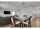 Dining area with hardwood floors, a chandelier, and an open view to the living room at 12685 E 104Th Pl, Commerce City, CO 80022